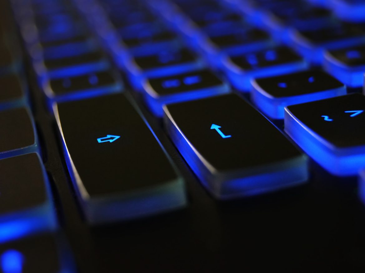 Close-up of a backlit blue computer keyboard
